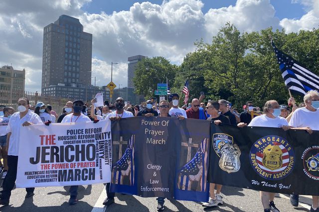 Current and former NYPD officers join a march organized by Black clergy on Wednesday.